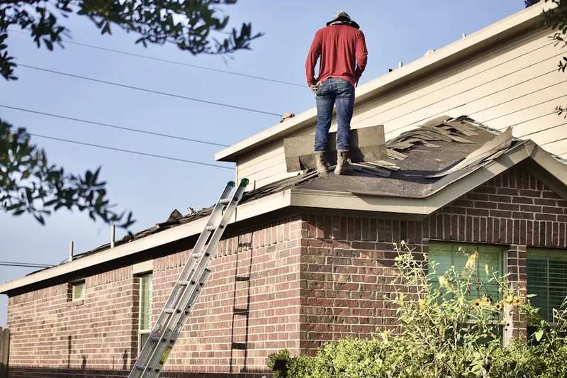 Professional roofer working on a residential roof in Chevington Place